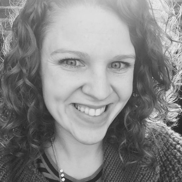Noelle Wyman Roth smiles for a headshot in black and white. 