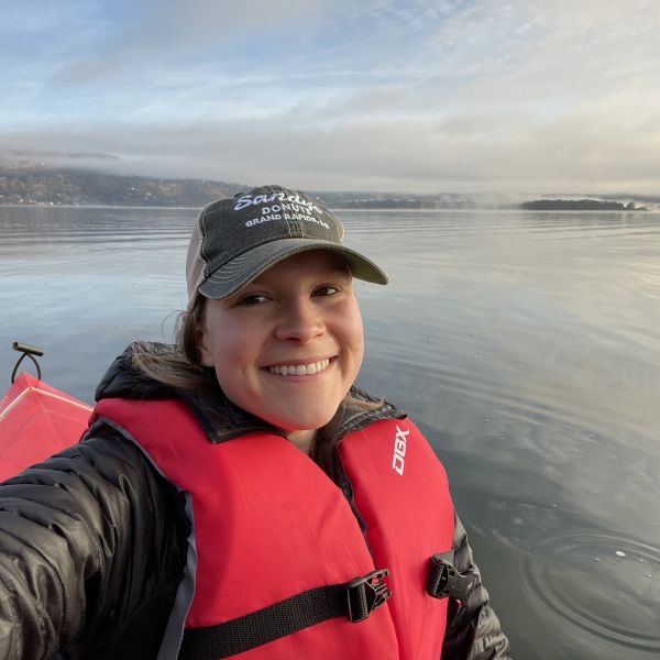 Rachel smiles for a selfie while kayaking. 